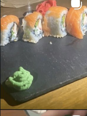 Salmon avocado sushi rolls plated with wasabi