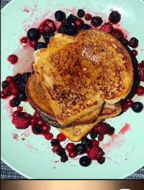 Brioche French toast stacked with fresh mixed berries