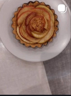 Apple rose tart baked in a fluted pastry shell