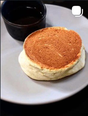 Tall Japanese soufflé pancake served with maple syrup