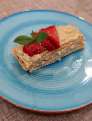 Mille-feuille napoleon topped with strawberries and mint