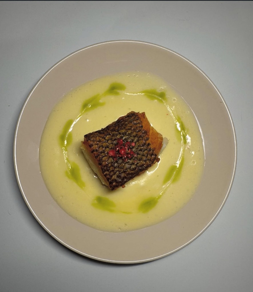 Crisp-skinned fish in a silky pale sauce with herb oil