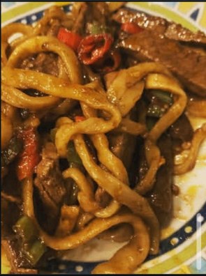 Beef udon noodles with peppers in a soy-glazed sauce
