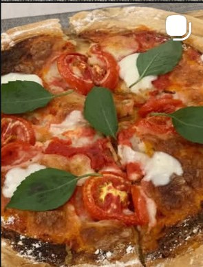 Margherita pizza with fresh basil and bubbling mozzarella