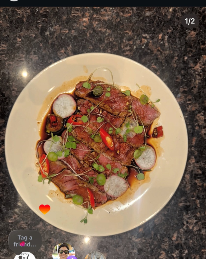 Beef tataki plated with radish, chili, and microgreens