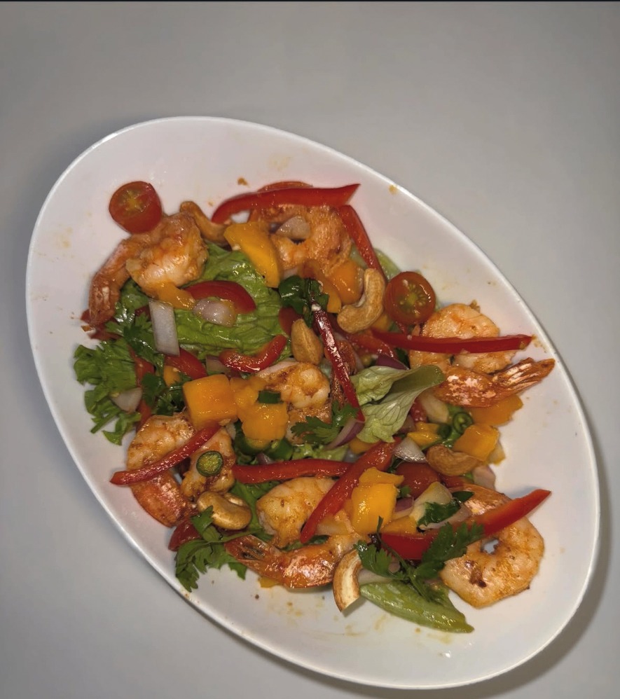 Shrimp and mango salad with peppers, cashews, and herbs