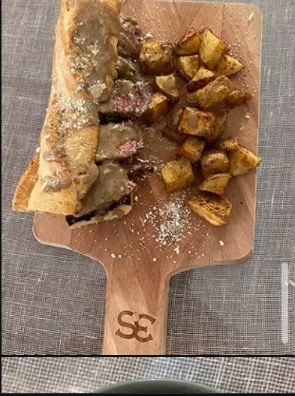 Steak crostini topped with crispy roasted potato cubes