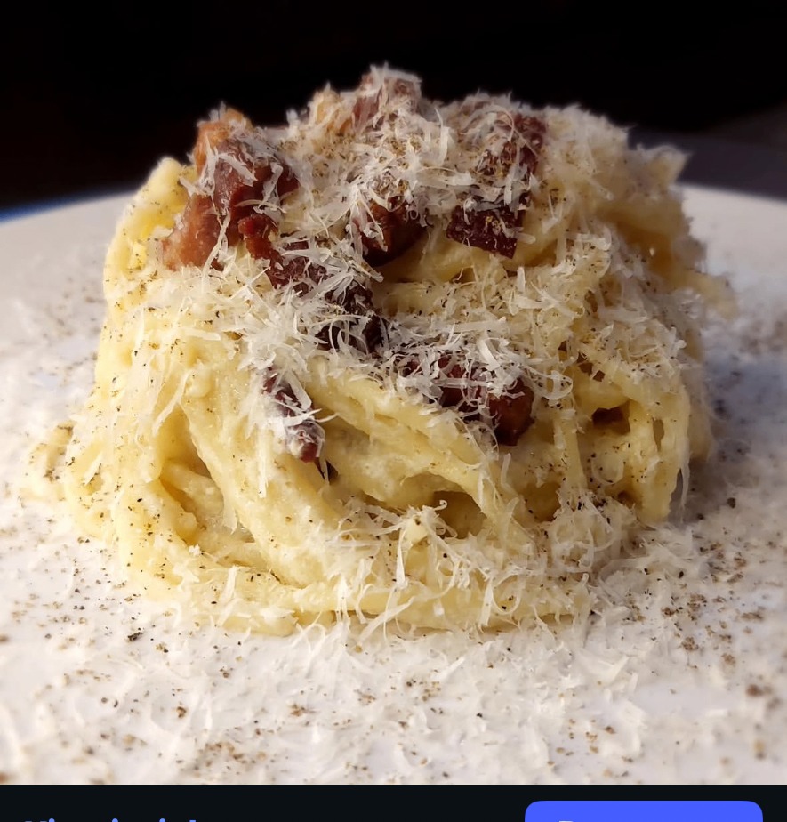 Creamy carbonara twirled into a nest with parmesan and crisp pancetta