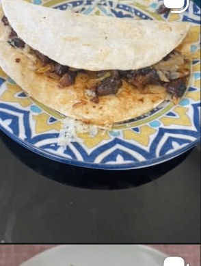 Black bean and mushroom quesadilla on a tiled plate