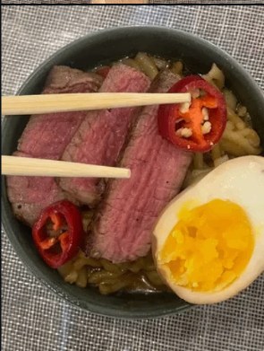 Tonkotsu ramen with seared steak, soft-boiled egg, and chili
