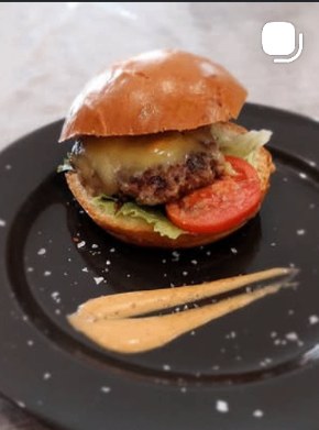 Smash burger with melted cheddar, tomato, and crisp lettuce