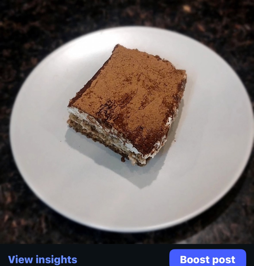 Classic tiramisu dusted generously with cocoa powder