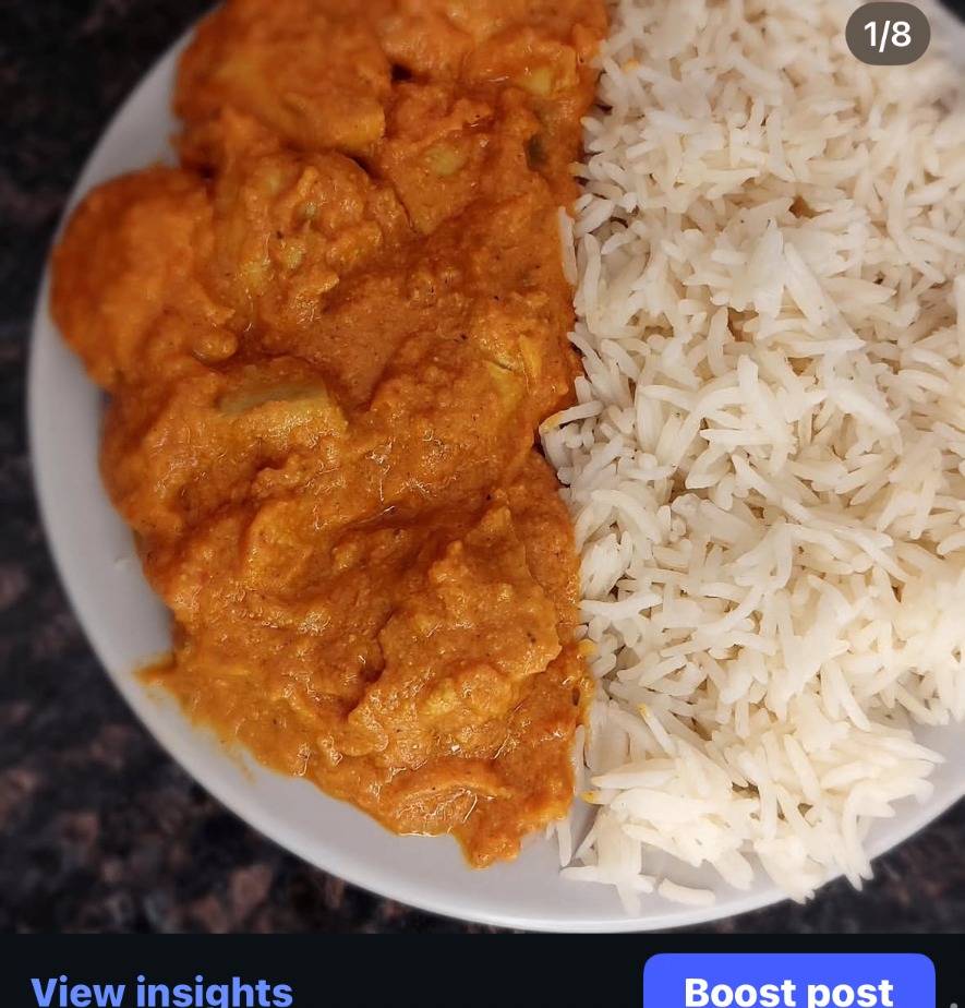 Butter chicken served with fluffy white rice